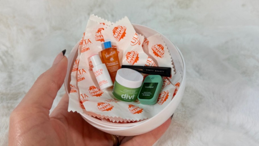 womans hand holding opened capsule