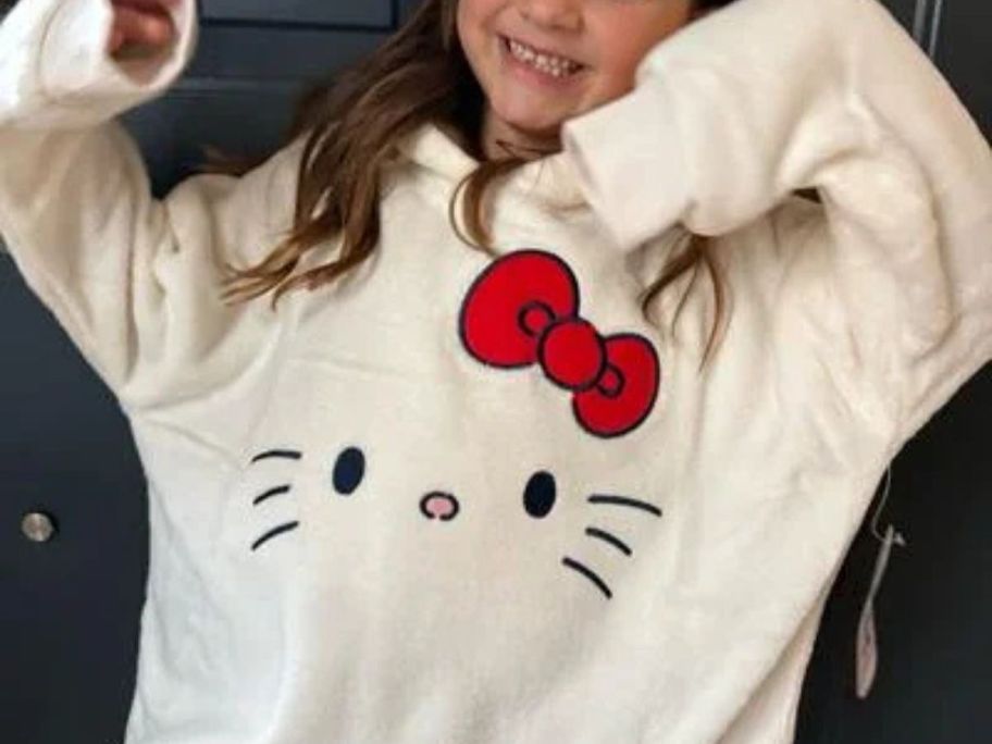 girl wearing hello kitty hooded blanket