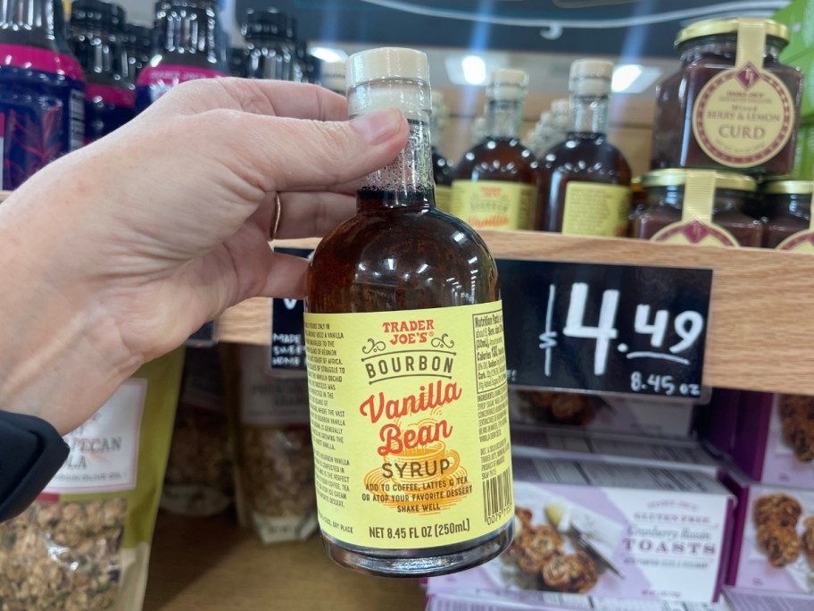 hand holding a bottle of vanilla bean sauce