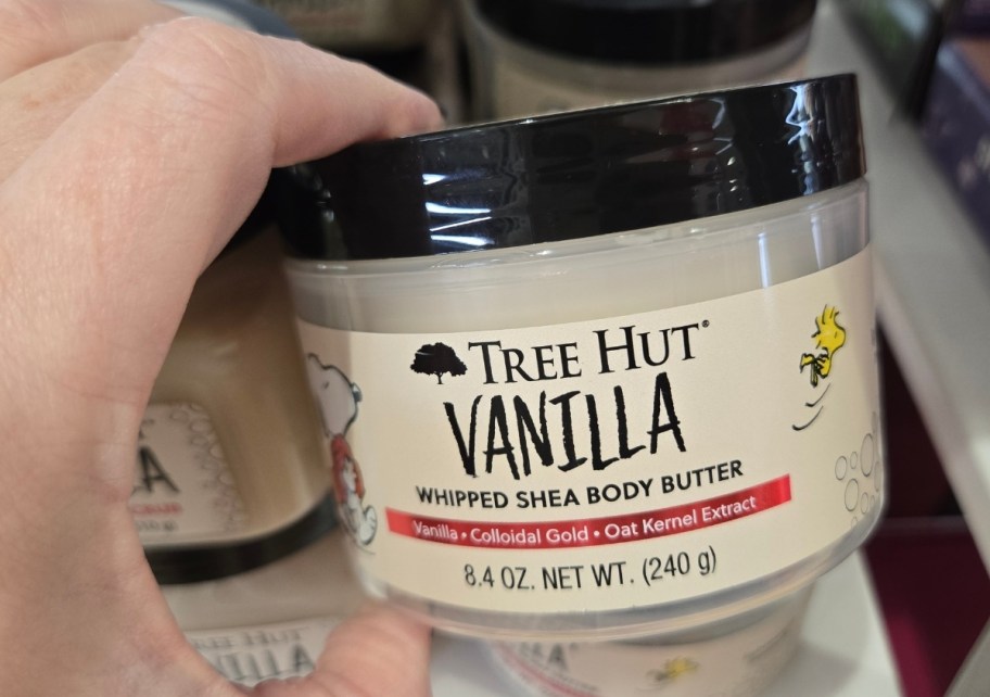 womans hand holding a jar ofwhipped shea body butter