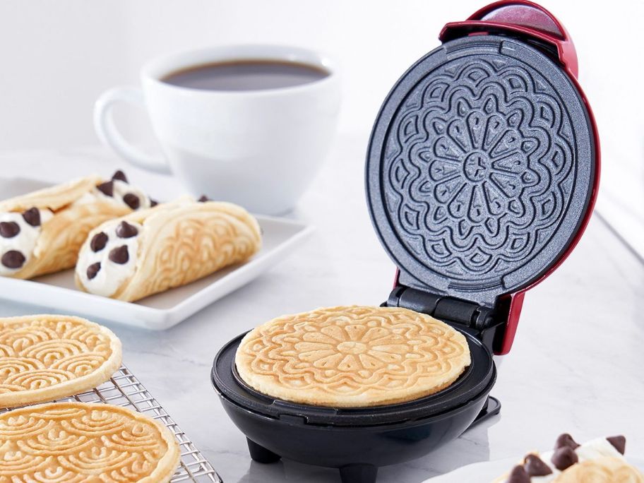 pizzelle waffle maker with items displayed on a plate 