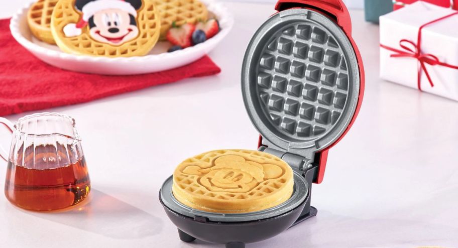 disney waffle maker displayed with food behind 