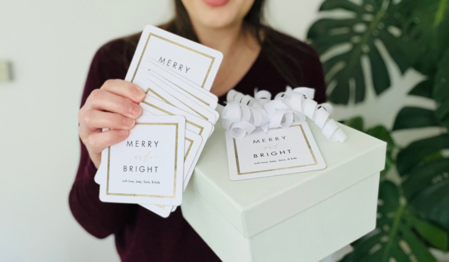 woman holding up coasters and a gift