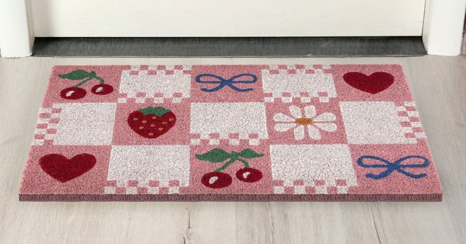 pink and white checkered doormat at doorstep