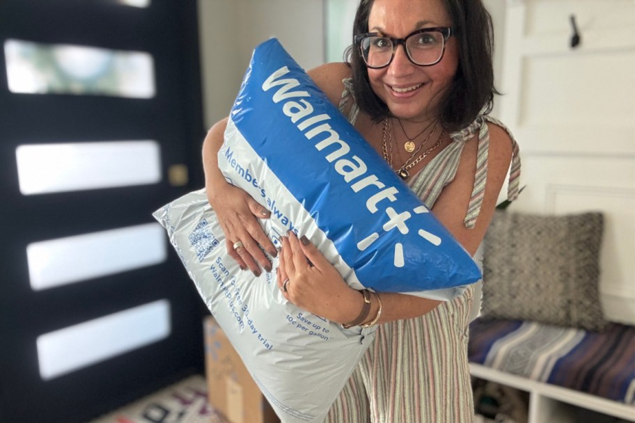 woman holding walmart package near black pane door