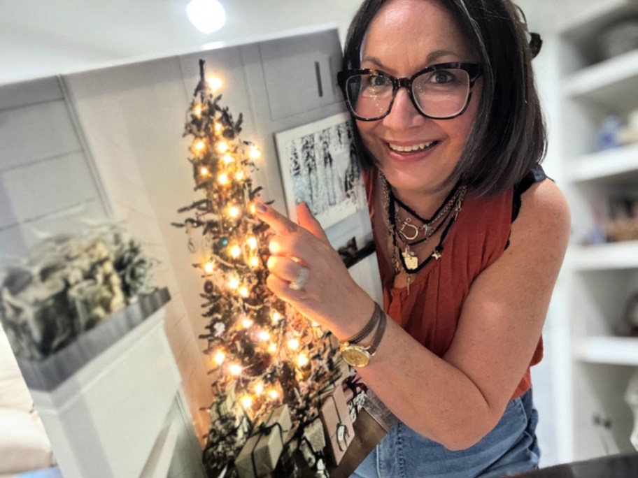 woman holding a light up photo canvas
