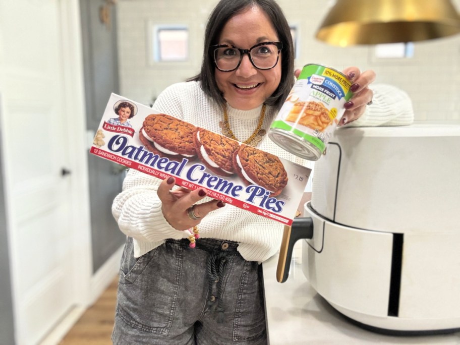 woman holding oatmeal cream pies and apple pie filling