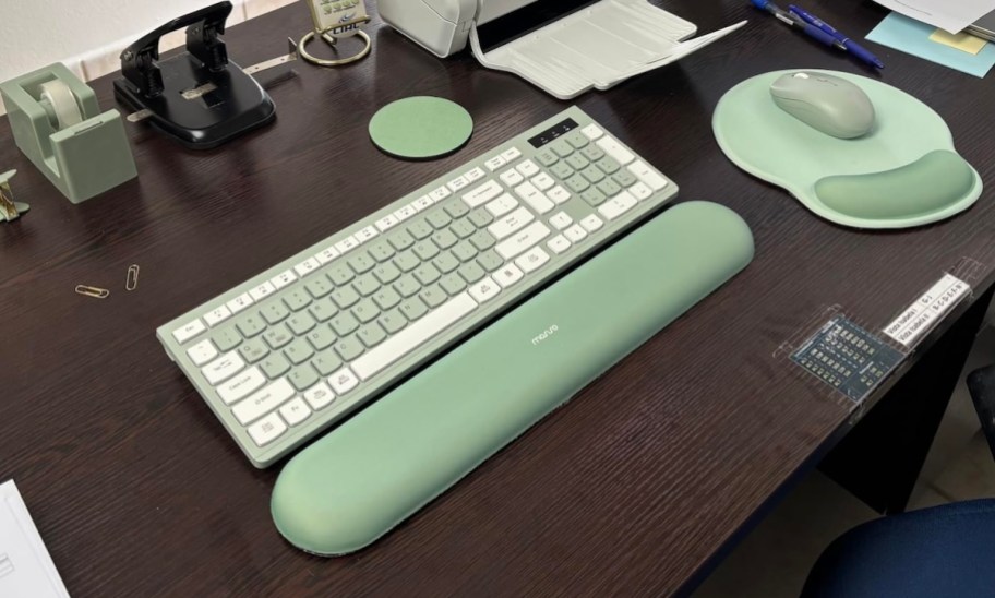 green wrist rest with green white keyboard on desk