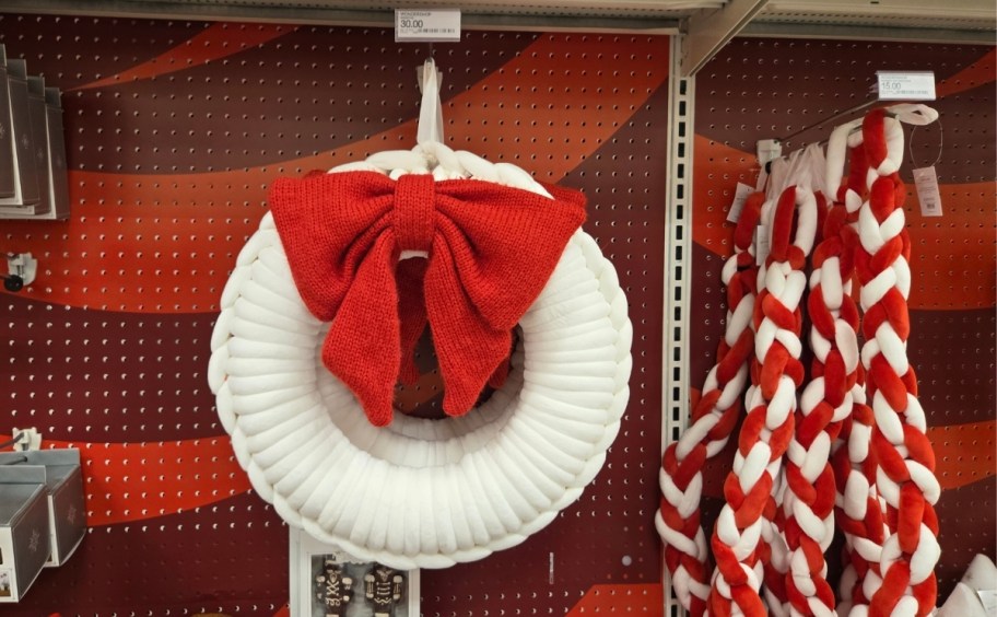 a white yarn wreath and red and white yarn garland