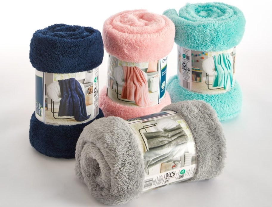 four kids throw blankets in different colors