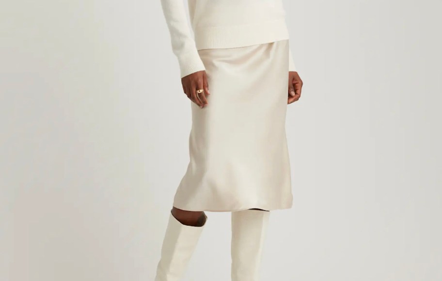 close up of woman wearing white silk shirt and sweater