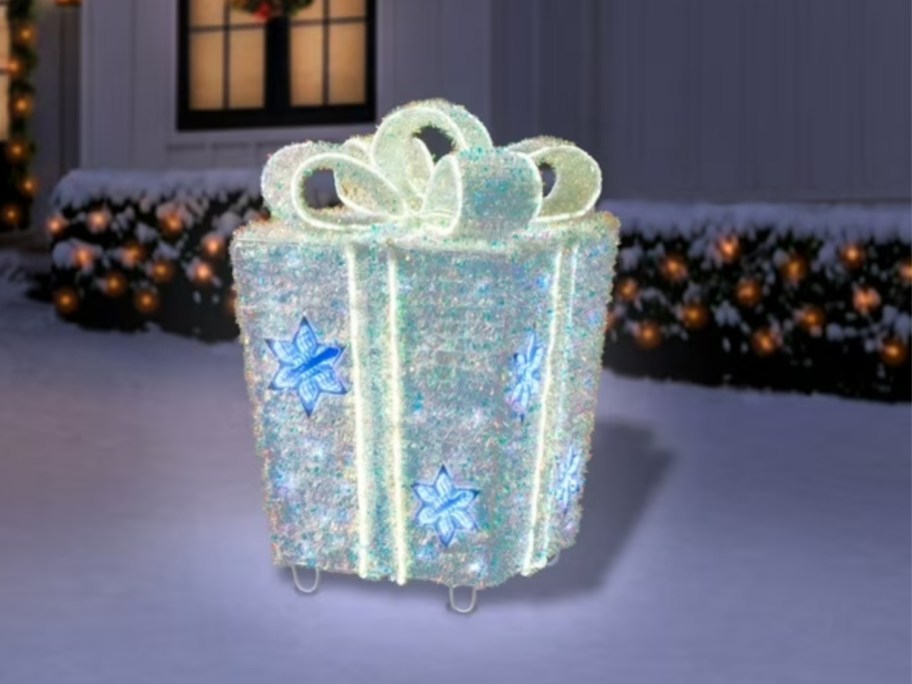 a large lit up present outdoor Christmas decor