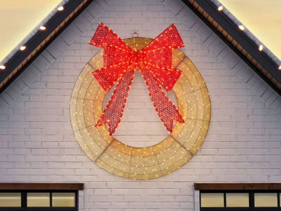 a large lit wreath on a house