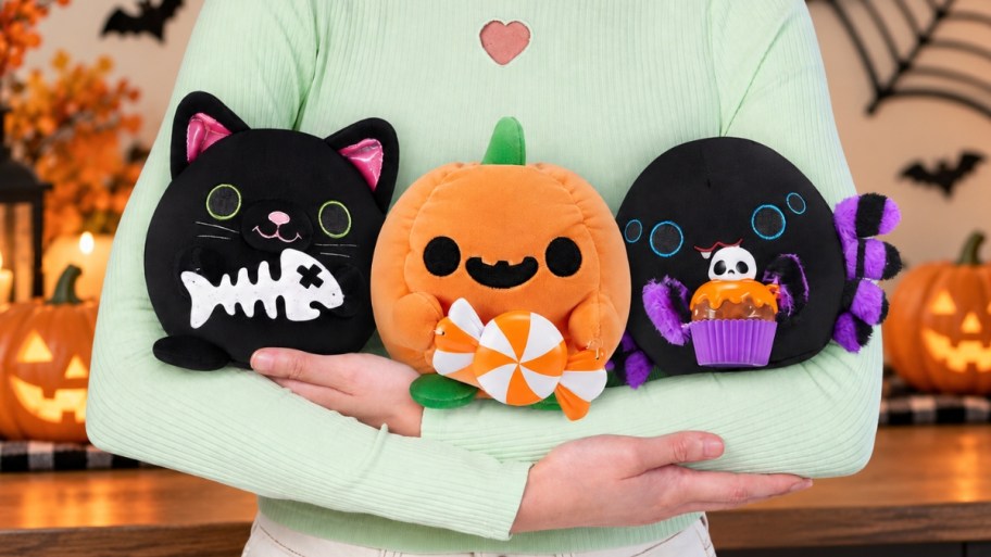 girls arms holding 3 halloween 5 in snackes blush toys