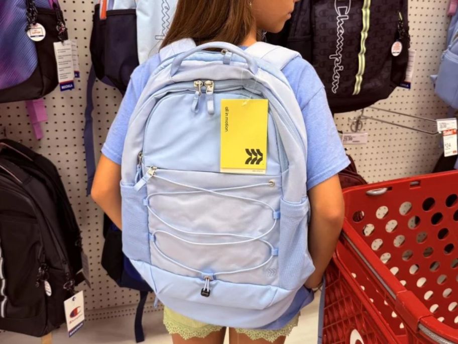 A girl wearing a purple backpack