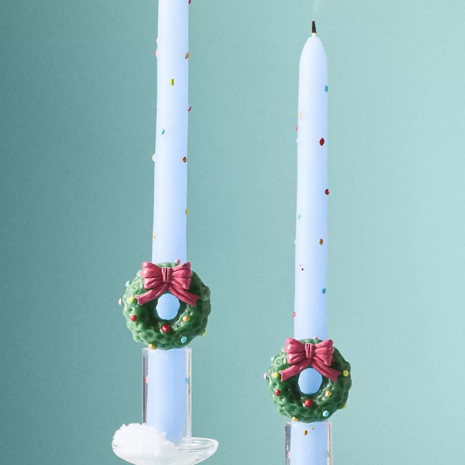 two different Anthropologie Festive Icon Taper Candles Set of 2