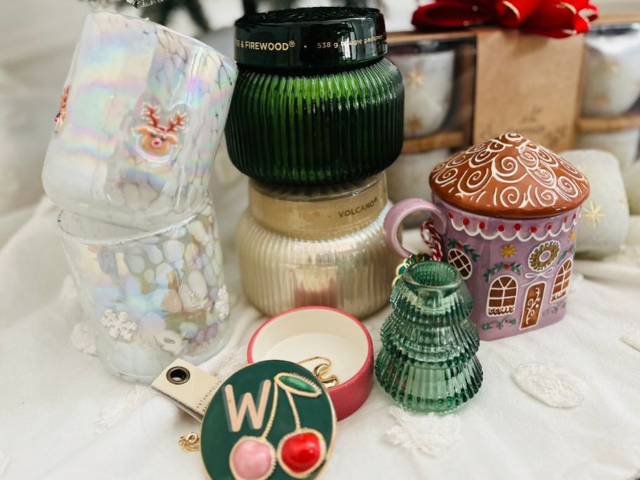 Anthropologie Gifts under a christmas tree including candles, glasses, a tricnket box and more.