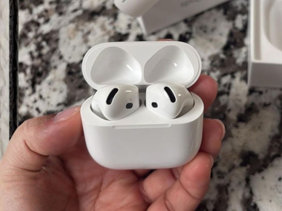 Apple AirPods 4 in hand