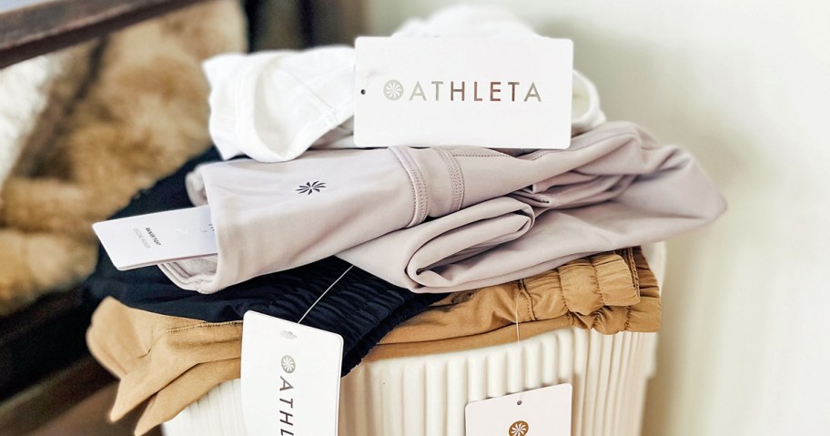 stack of folded clothing with athleta tags