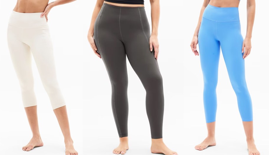 3 women modeling white, dark grey, and blue leggings