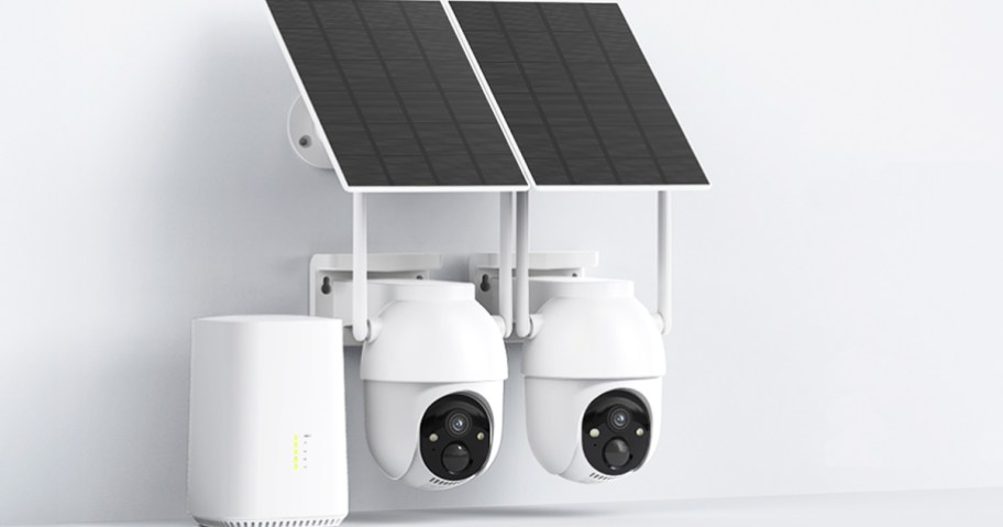 two white security cameras and home base