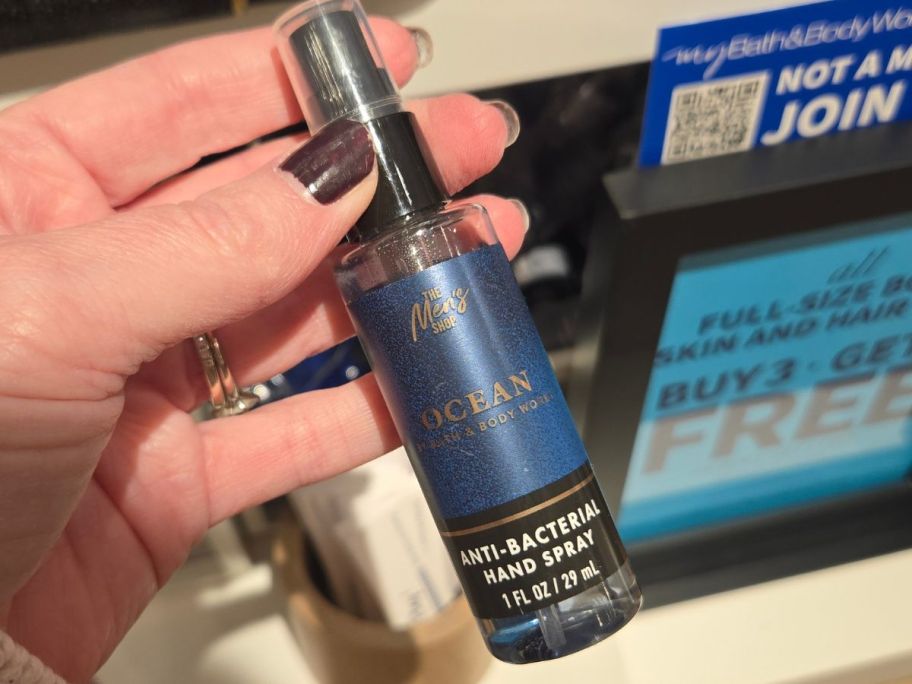 Hand holding a bottle of Bath & Body Works Hand sanitizer Spray