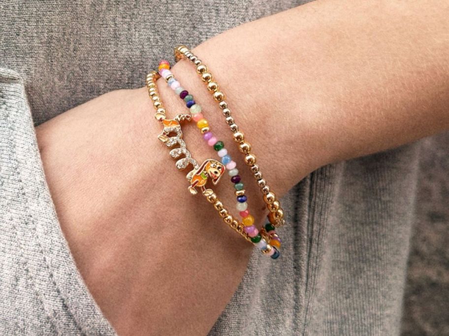 A person wearing a Disney Slinky Dog bracelet 