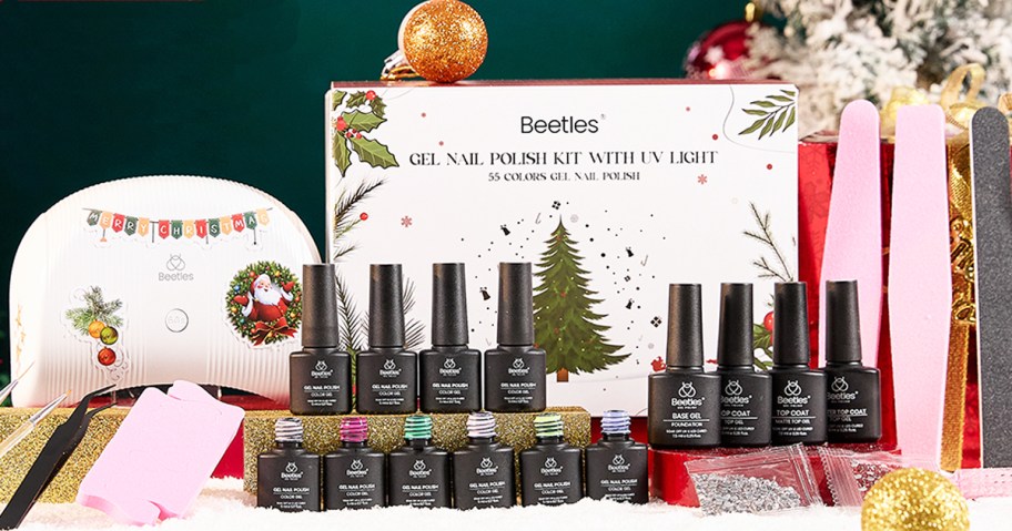 christmas-themed gel polish kit with lamp, nail polish bottles, and nail tools