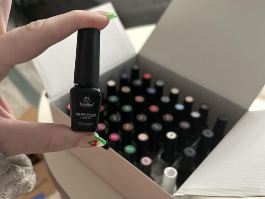 Hand holding a Beetles Gel Nail Polish Kit