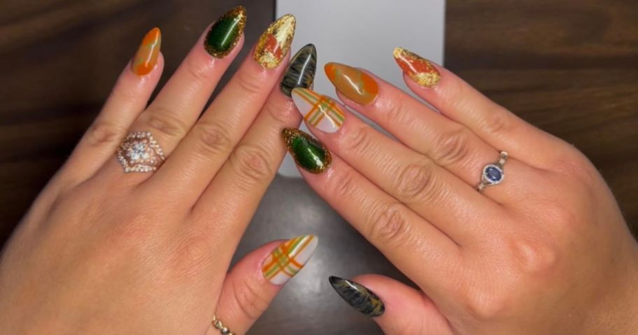 Woman's hand with a gel manicure in fall colors