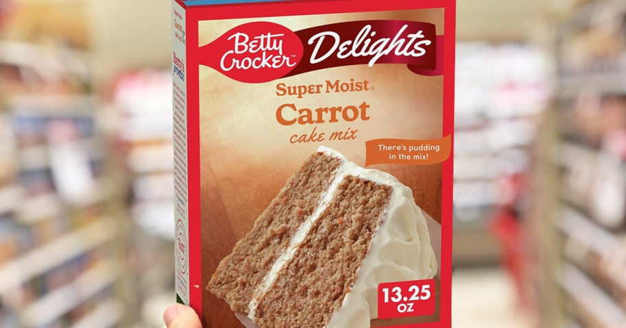 hand holding box of Betty Crocker Carrot Cake Mix in store