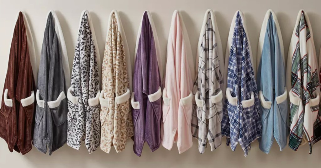 Macy's blanket wraps hanging on hooks on wall