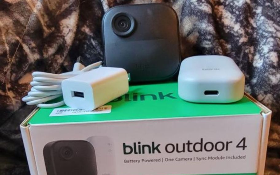 Blink camera bundle displayed on top of the bed