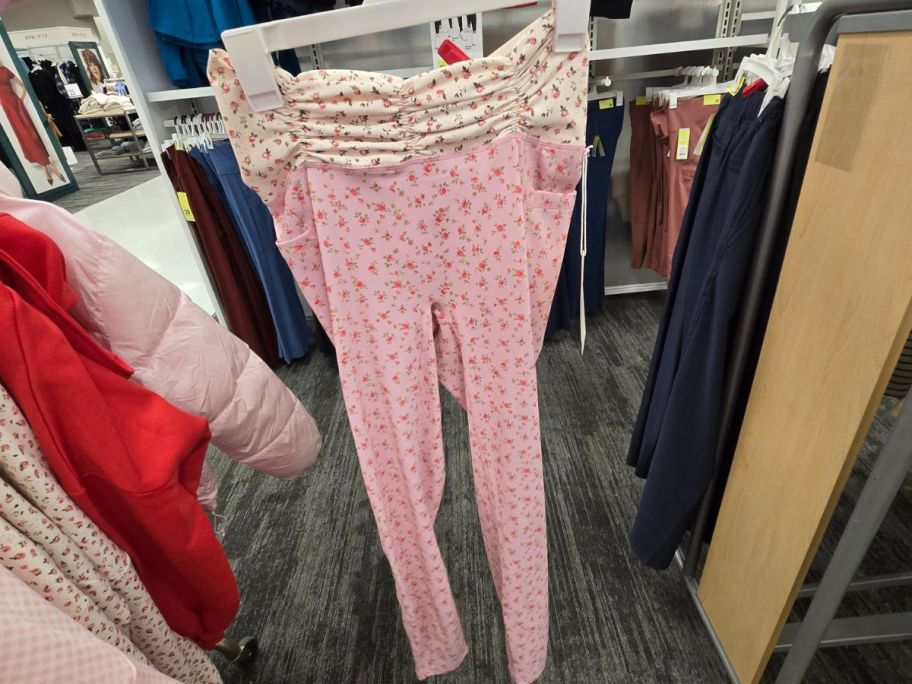 A person holding a piar of pink and white leggings