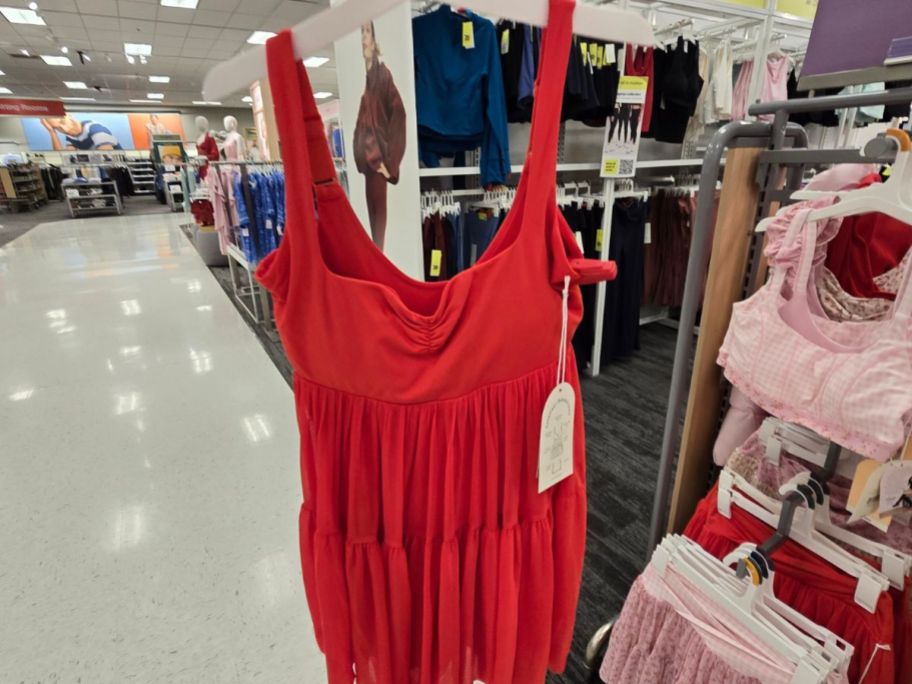 A person holding a red dress