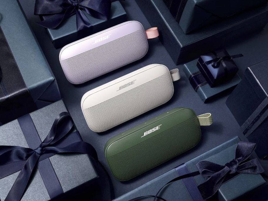 3 Bose soundlink speakers in lilac, white and green
