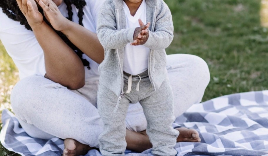 baby boy wearing burt's bees baby pants and hoodie in gray with white shirt
