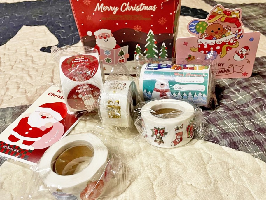 rolls of christmas gift tags and stickers outside of their box