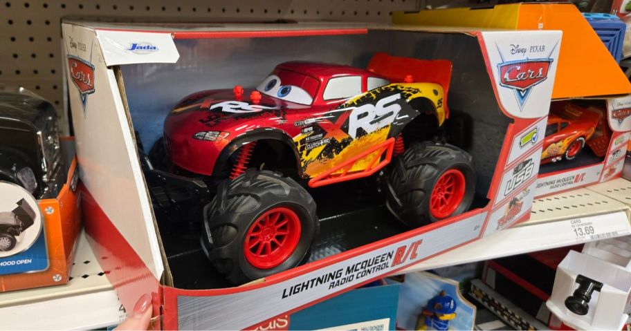 A red Disney Lightning McQueen RC Car on a shelf