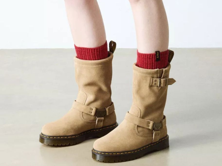 Woman's feet wearing Dr. Martens Ansitone Hi Suede Biker Boots