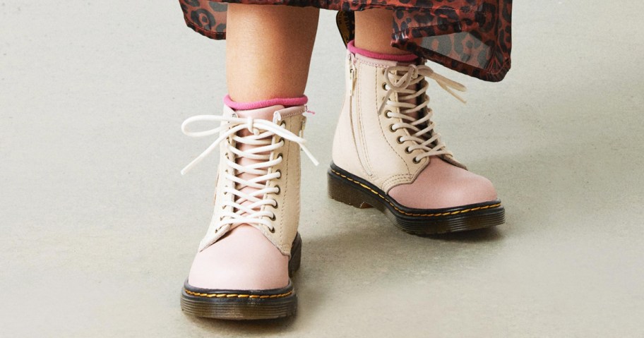 girl wearing a pair of white and pink leather boots