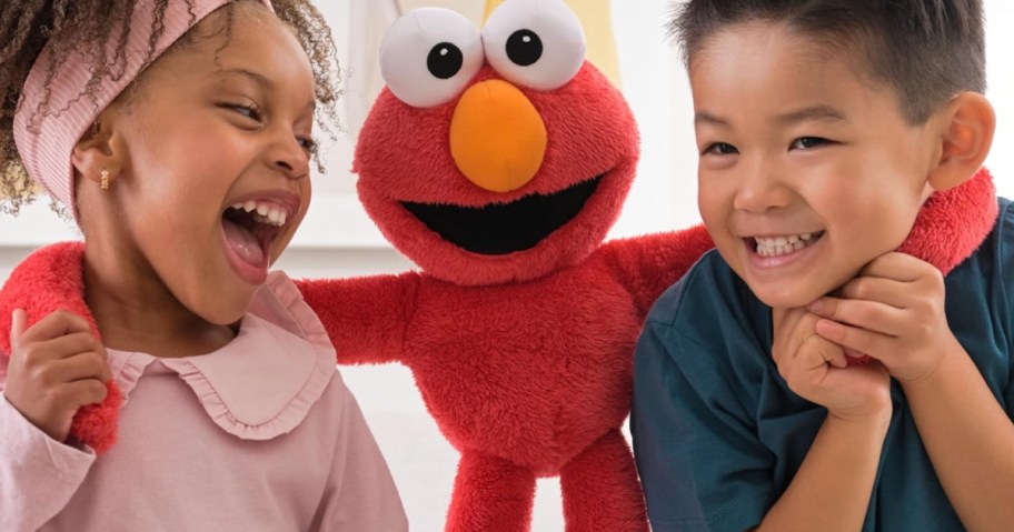 Little boy and girl, hugging, red Elmo, plush doll