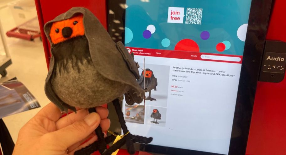 hand holding Featherly Friends Lewis & Friends 'Lewis' Halloween Bird Figurine in front of target scanner