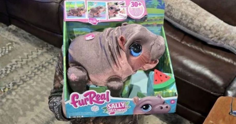 FurReal Child holding Sally the stupid hippopotamus