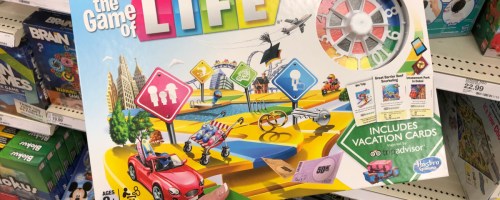 Person holding up game of life game inside target store aisle