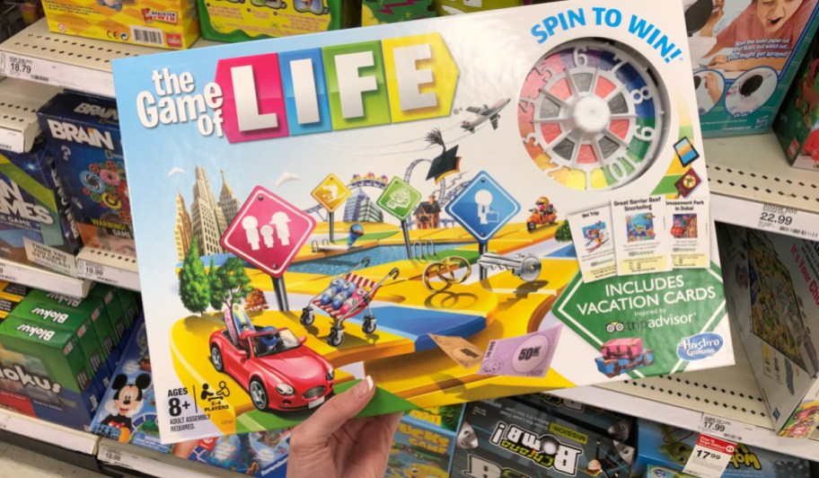 Person holding up game of life game inside target store aisle