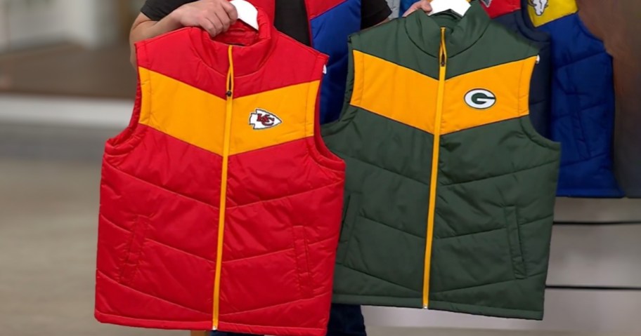 hands holding two NFL puffer vests Kansas City Chiefs and Green Bay Packers