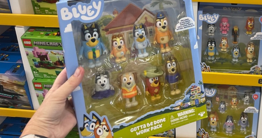 hand holding a Bluey figures set