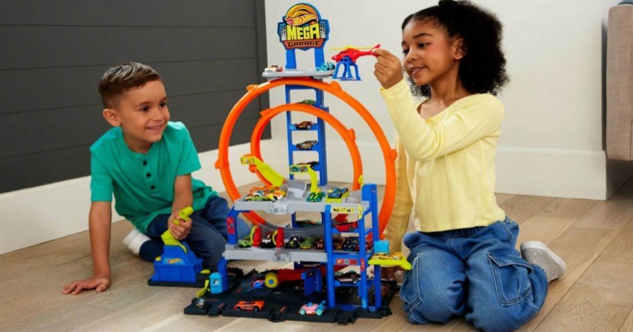 2 kids playing with a Hot Wheels Mega Loop Garage Playset