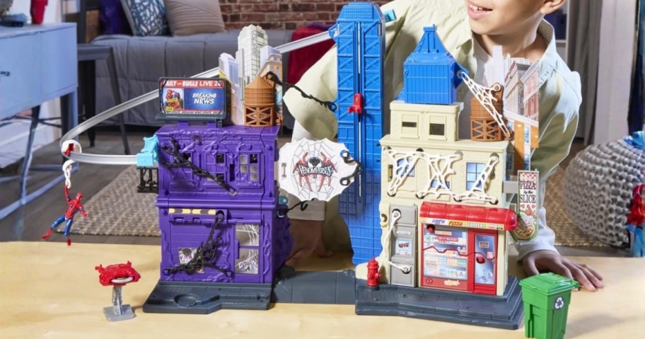 kid playing with a Marvel Spider-Man Versus Venom Web Slinging City Playset
